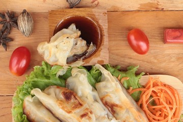 Fried gyoza and sauces - traditional Japanese food.