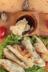 Fried gyoza and sauces - traditional Japanese food.