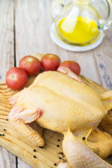 Raw chicken on wooden table