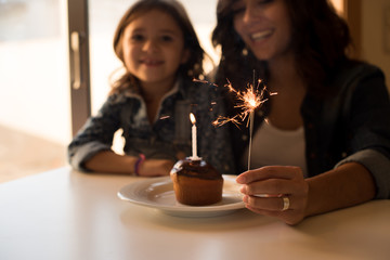 Mom and daughter celebarting birthday - Focus on Sparkler