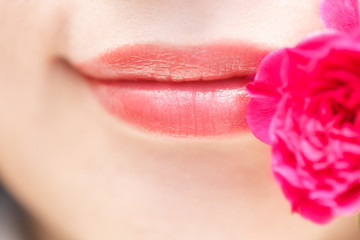 A woman's lips and red rose.