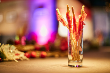 Grissini bread sticks with prosciutto ham