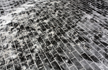 Snow on pavement stones.