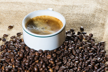 Cup of coffee and coffee beans in sack