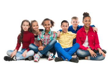 teenager friends sitting on the floor embracing