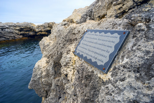Plaque with  inscription on the stone by  sea.