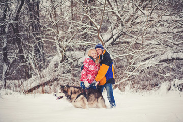 Happy couple standing with a dog