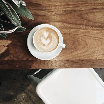 Overhead view of a latte coffee on a table