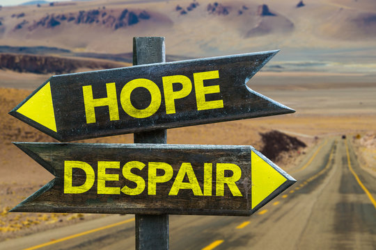 Hope - Despair signpost in a desert road on background
