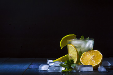 Glass of lemonade with mint leaves and ice cubes