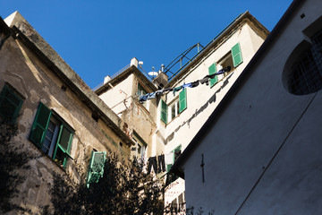 Fototapeta na wymiar typical scene of hanging clothes in Genoa's streets, suny day,outdoor