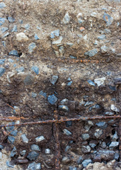 Steel rusty rods in gray concrete wall. Abstract texture backgro