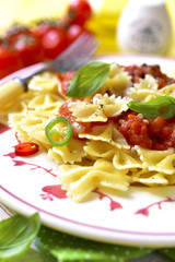 Pasta farfalle with tomato sauce.
