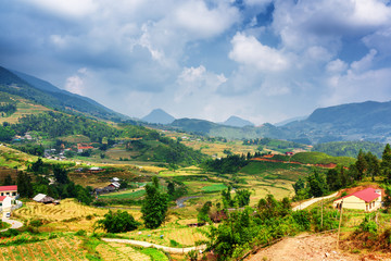 Fototapeta na wymiar View of village and rice terraces at highlands. Sa Pa, Vietnam