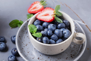 Strawberries and Blueberries on metal background