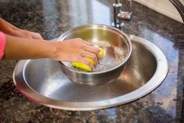 Close up of woman cleaning pot