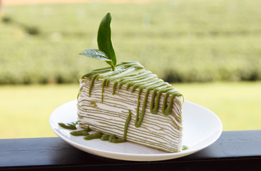 Green tea crepe cake on white disk