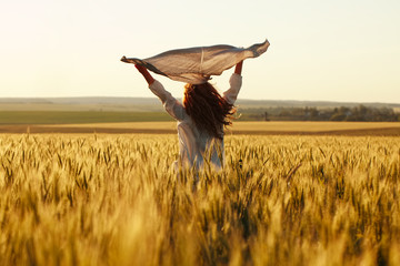 Happy woman with a scarf in the field
