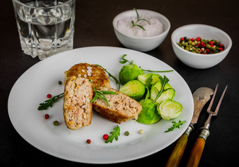 Fried pork meatballs served with brussels sprouts and arugula