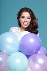 Fototapeta na wymiar Happy young woman with colorful latex balloons,