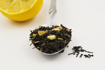 tea with lemon peel in a spoon on a white background
