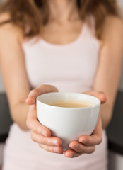 Woman holding coffee cup in her hands