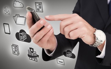 Composite image of businessman in glasses using his tablet pc