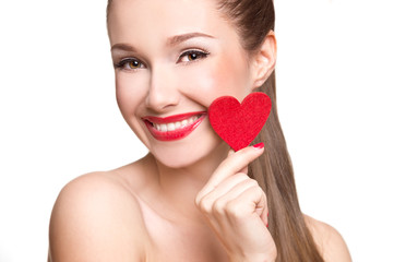 Love and valentines day woman holding heart smiling cute. Portrait of Beautiful woman with bright makeup and red heart in hand
