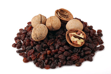 Scattering of dark raisin and walnuts on a white background.