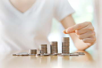 women put coin stack money. Financial planning action home office photography indoor environment close-up view savings concept