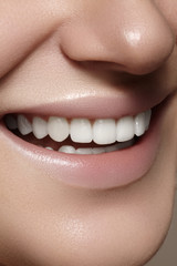 Beautiful smile with whitening teeth. Dental photo. Macro closeup of perfect female mouth, lipscare rutine
