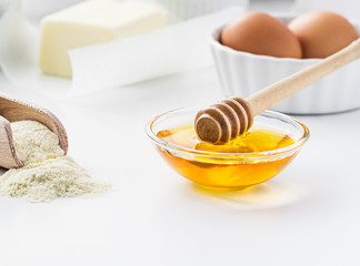 Basic ingredients for baking -eggs, flour,  butter with honey.