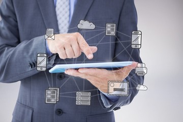 Composite image of businessman using tablet pc