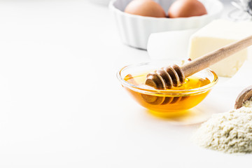 Baking background with  recipe ingredients- honey, eggs, flour,  butter.