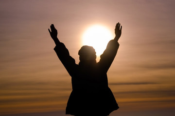 Women relaxing extend the arms in natural, silhouette