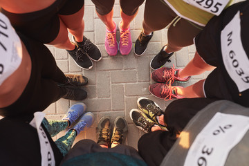 Feet of runners standing in a circle