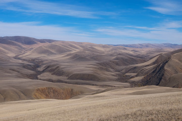 Fototapeta na wymiar Mountains, the steppe and the sky