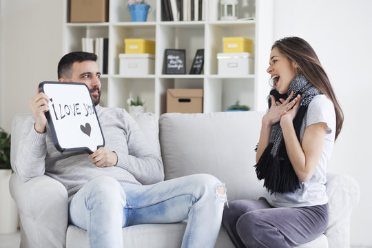Young couple showing love message written on white board. I love you message. Valentines couple,shallow depth of filed