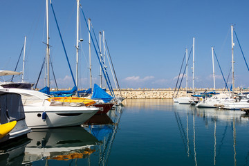 Fototapeta na wymiar Boats reflected in the water. Herzliya Marina. Israel