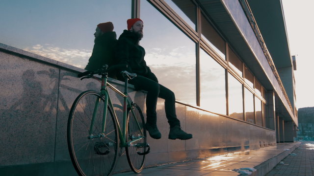 Guy riding fixed gear bike on background of the port, 4k