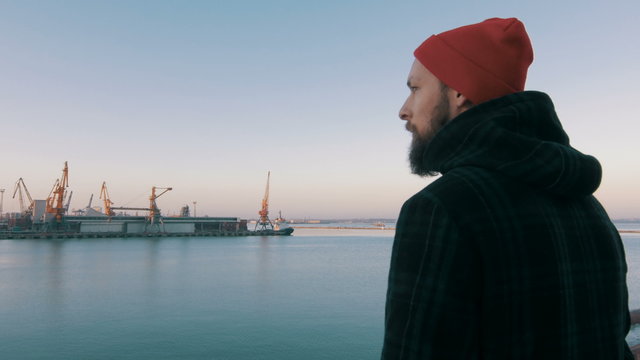 Guy riding fixed gear bike on background of the port, 4k