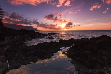 Beautiful sunset along the lava rock coast of Kauai Hawaii