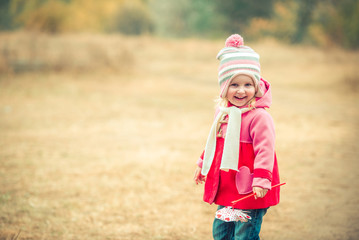 Fototapeta premium little smiling girl on autumn landscape