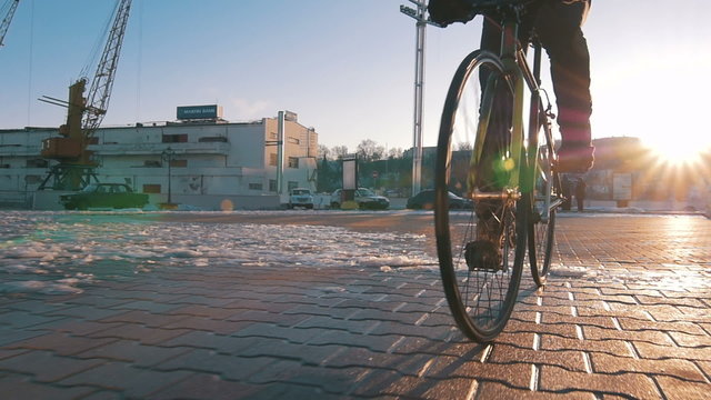 Guy riding fixed gear bike in marine station, slow motion