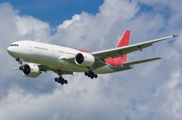 Passenger jet airplane in the sky with gear down