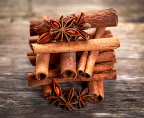Cinnamon sticks and anice on wooden table. selected focus