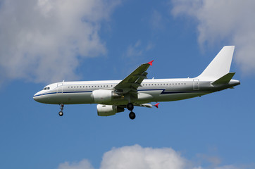 Fototapeta na wymiar Passenger jet airplane in the sky with gear down
