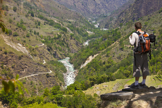 hiker stands on the hill enjoying the view