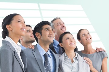 Composite image of business people looking up in office