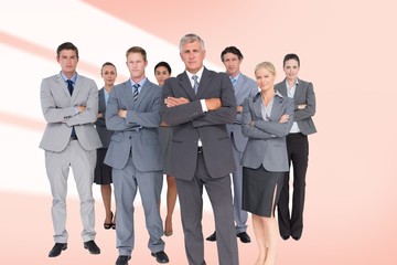 Fototapeta na wymiar Composite image of business team standing arms crossed 